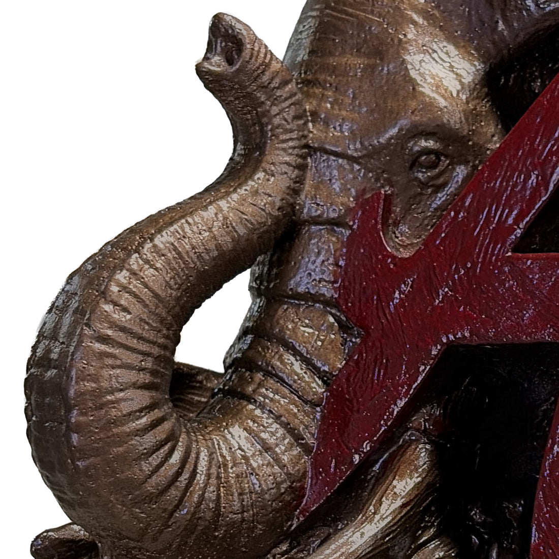 Close-up of the curled elephant trunk and tusk detail on the Alabama Crimson Tide elephant and script A desk sculpture, bronze metal coating