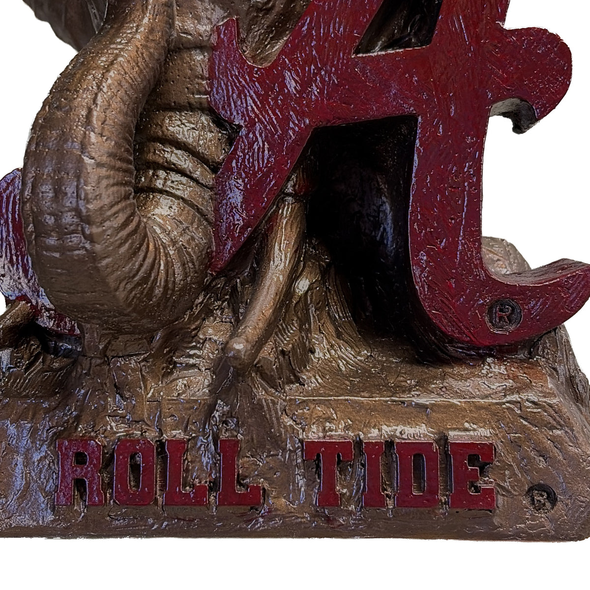 Close-up of the raised crimson ROLL TIDE lettering on the base of the Alabama Crimson Tide elephant and script A desk sculpture
