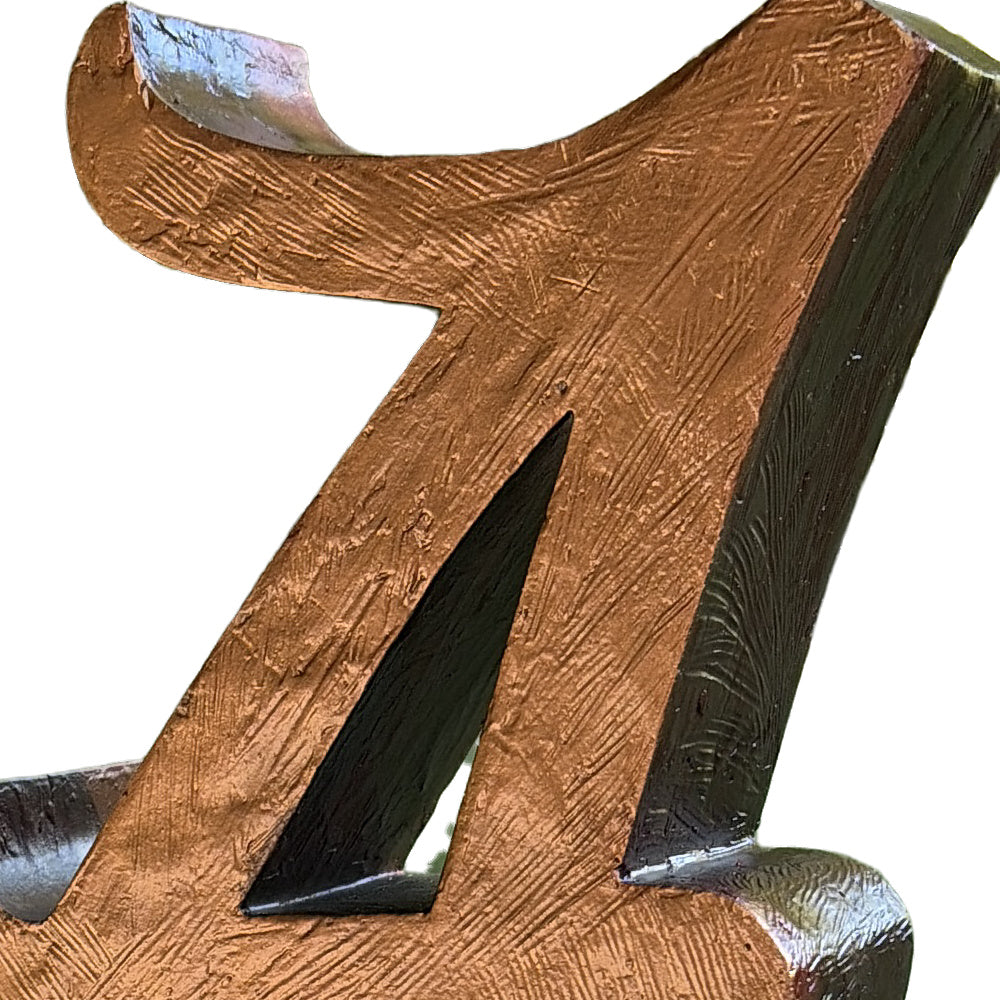 Close-up of the hand-textured bronze metal coating on the Alabama Script A porch statue